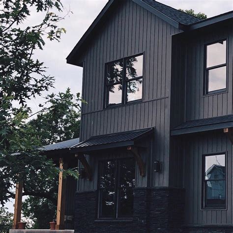 dark gray house with metal roof|gray exterior with black trim.